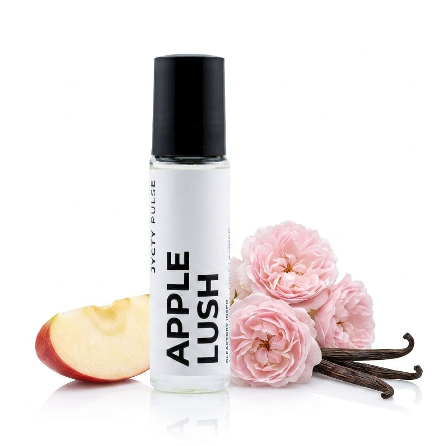 A clear cylindrical bottle with a black cap labeled 'APPLE LUSH' by Ticky Pulse, styled with a sliced red apple, pink roses, and vanilla beans on a white background.
