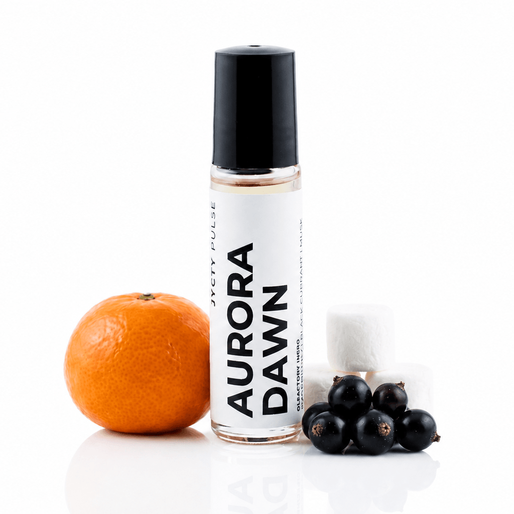 A clear cylindrical roller bottle with a black cap and a white label reading 'AURORA DAWN' and 'JYCTY PULSE', shown on a white background with an orange, white flower, and dark berries beside it.