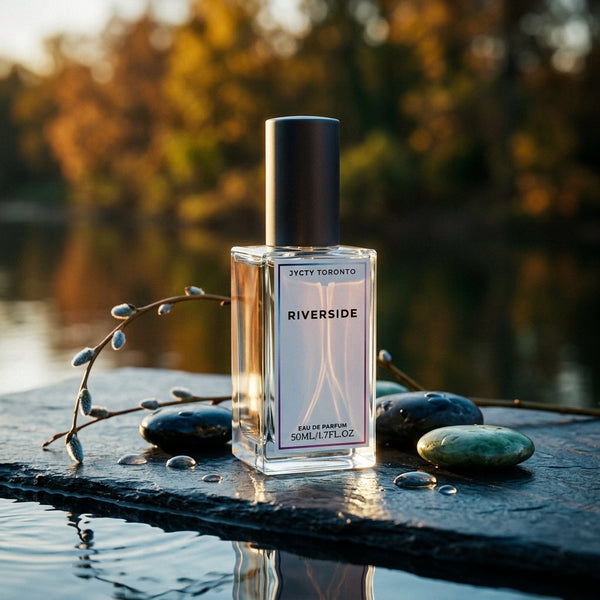 Perfume bottle labeled 'Riverside' by JYCTY Toronto on a stone surface with a natural background.