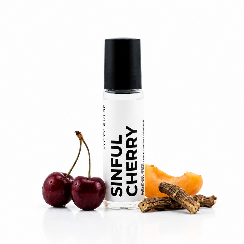 A clear cylindrical bottle with a black cap labeled 'SINFUL CHERRY' stands on a white reflective surface, styled with two dark red cherries, a slice of orange, and dried bark pieces. The brand 'JYCTY Pulse' is visible on the bottle.
