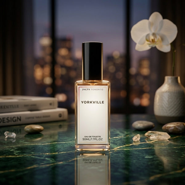 50ml Perfume bottle labeled 'Yorkville' on a reflective surface with a blurred cityscape background